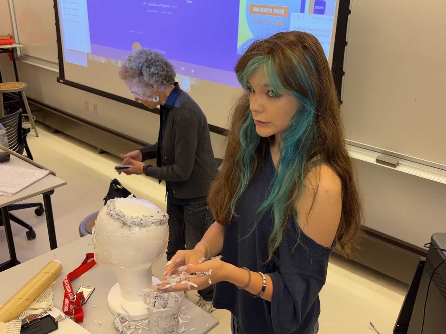 Eden working with paper material in the studio